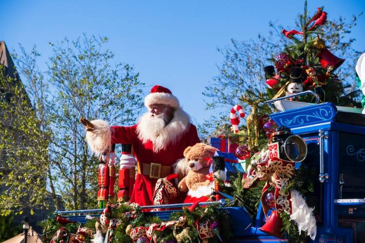 santa on float in Christmas parade toys and teddy bear next to him