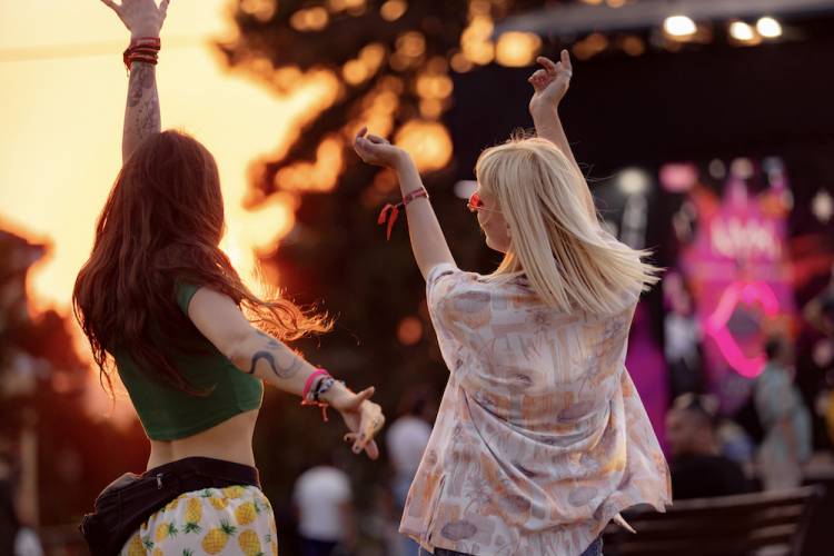 two girls dancing at outdoor concert
